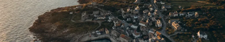 Aerial view of a small waterside village and its harbor at sunset (example photo)